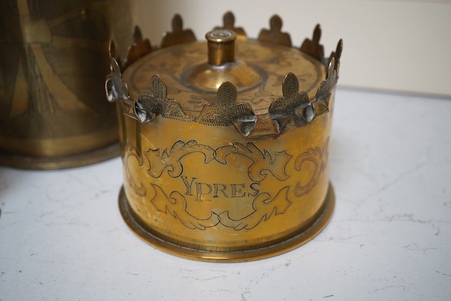 Trench Art, an engraved brass shell case, a similar box engraved ‘Ypres’ and a trivet, largest 50cm high. Condition - fair/good
